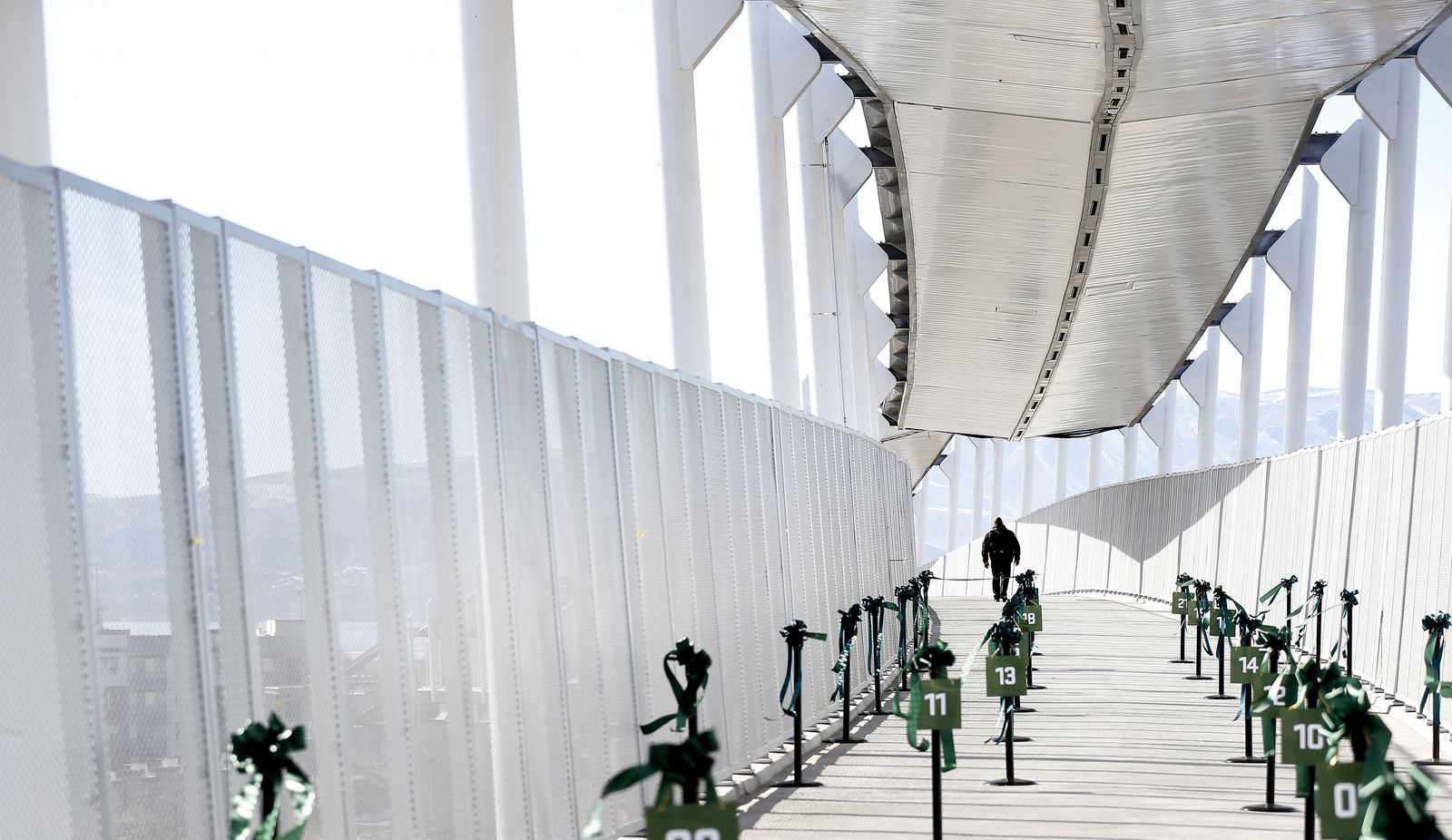 A person walks across the new pedestrian bridge connecting Utah Valley University with the Utah Transit Authority’s FrontRunner Orem Central Station on Thursday, Jan.14, 2021.