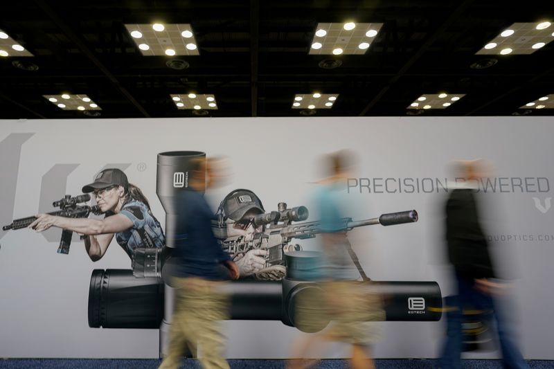 FILE PHOTO: Attendees walk around at the National Rifle Association's (NRA) annual meeting, in Indianapolis, Indiana, U.S., April 28, 2019. REUTERS/Bryan Woolston/File Photo