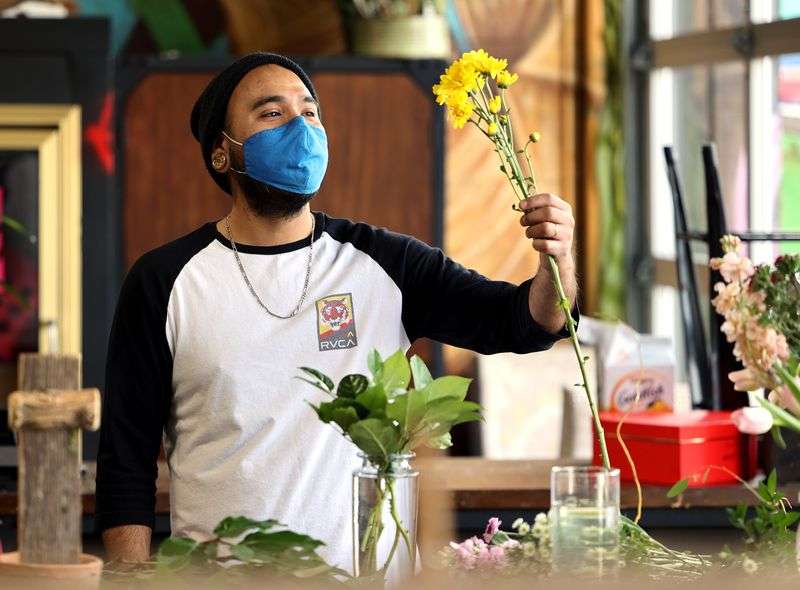 Designer Rodrigo Cabral evaluates flowers at Especially
For You Your Downtown Florist in Salt Lake City on Tuesday, Jan.
12, 2021. The shop’s owner, Marci Rasmussen, applied for Paycheck
Protection Program funding during the first round of stimulus last
year to keep her business afloat and will also apply for the latest
round of funding.