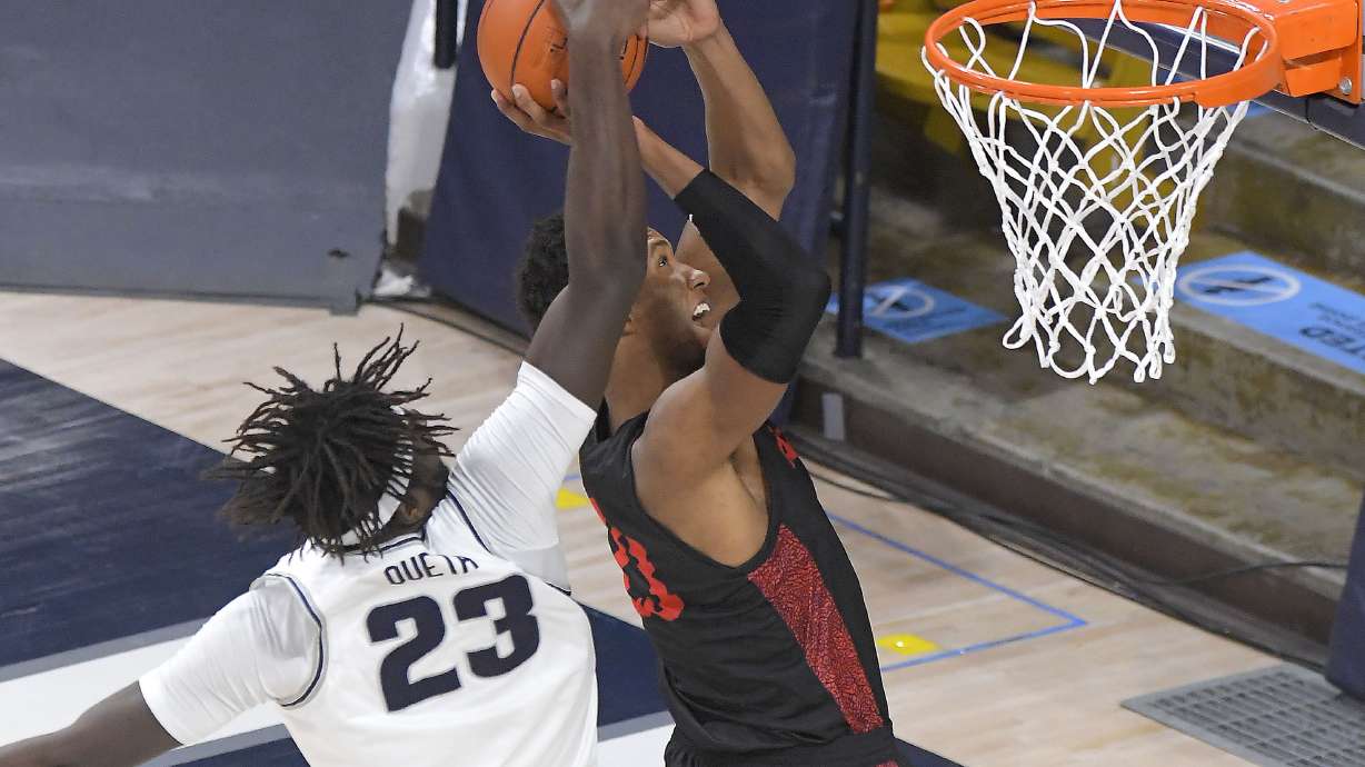 Utah State center Neemias Queta (23) blocks the shot of San Diego State forward Joshua Tomaic during the first half of an NCAA college basketball game Saturday, Jan. 16, 2021, in Logan, Utah. (Eli Lucero/The Herald Journal via AP, Pool)