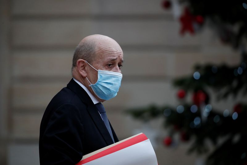 FILE PHOTO: French Foreign Minister Jean Yves Le Drian, wearing a protective face mask, leaves following the weekly cabinet meeting at the Elysee Palace in Paris, France, January 6, 2021.  REUTERS/Benoit Tessier
