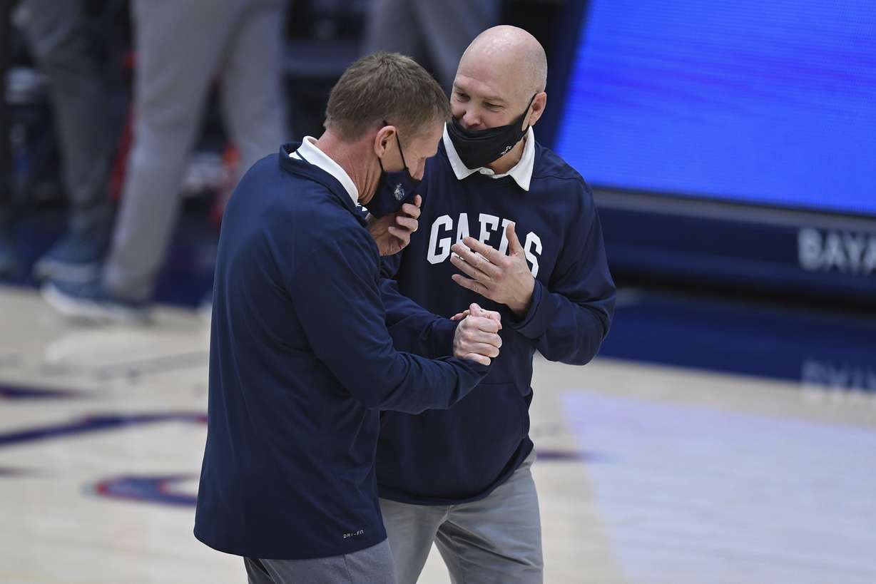 Gonzaga coach Mark Few, left, greets Saint Mary's coach Randy Bennett before an NCAA college basketball game in Moraga, Calif., Saturday, Jan. 16, 2021.