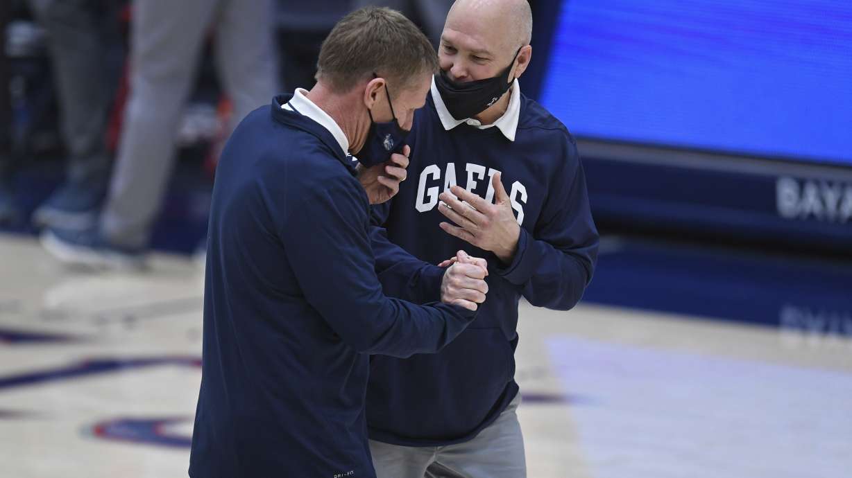 Gonzaga coach Mark Few, left, greets Saint Mary's coach Randy Bennett before an NCAA college basketball game in Moraga, Calif., Saturday, Jan. 16, 2021.