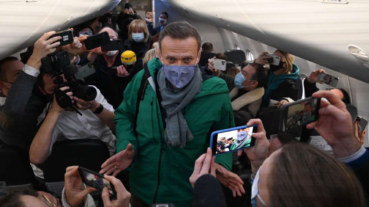 Russian opposition leader Alexei Navalny walks to take his seat on a Pobeda airlines plane heading to Moscow before take-off from Berlin Brandenburg Airport (BER) in Schoenefeld, southeast of Berlin, on Jan. 17.