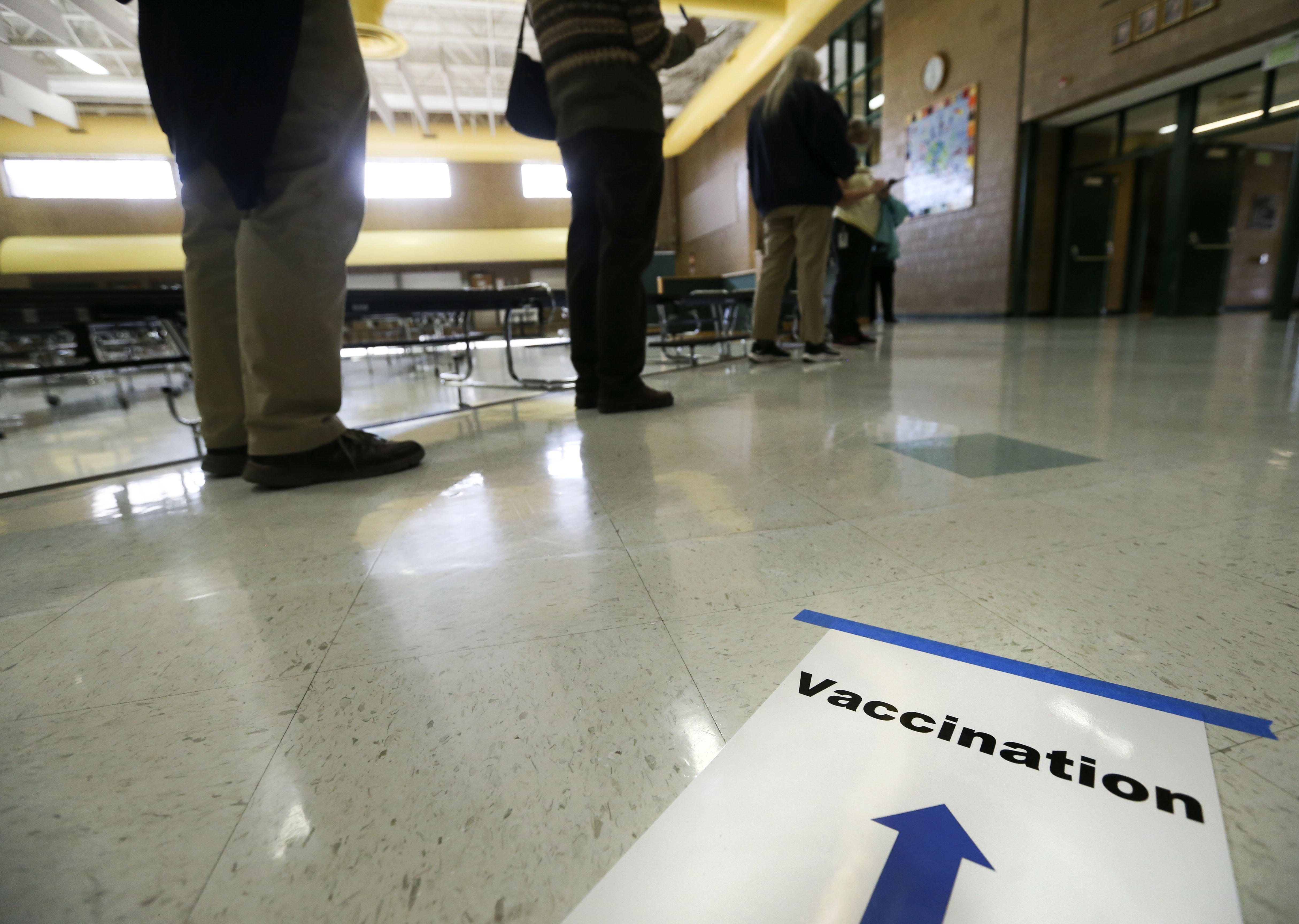 Granite School District teachers and staff wait in line to receive the first round of the COVID-19 vaccine at Hunter Junior High School in West Valley City on Friday, Jan.15, 2021.