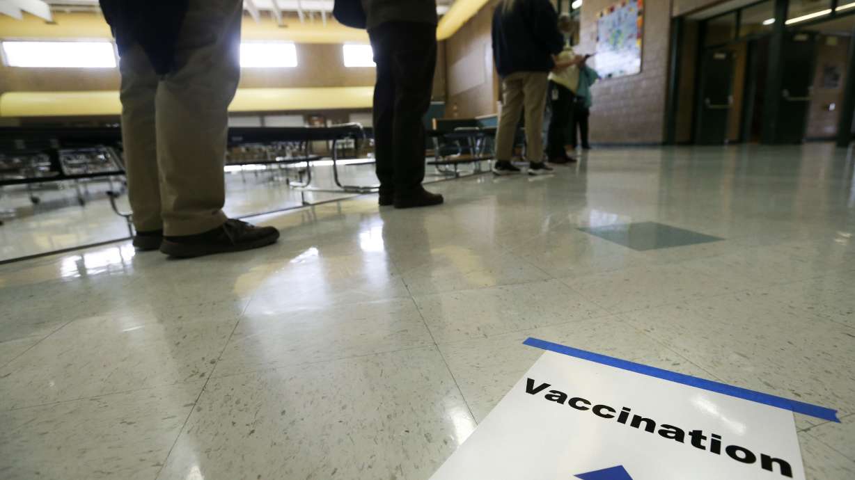 Granite School District teachers and staff wait in line to receive the first round of the COVID-19 vaccine at Hunter Junior High School in West Valley City on Friday, Jan.15, 2021.