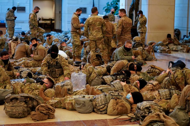 National Guard members gather and rest, before Democrats begin debating one article of impeachment against U.S. President Donald Trump at the U.S. Capitol, in Washington, D.C., on Jan. 13, 2021.