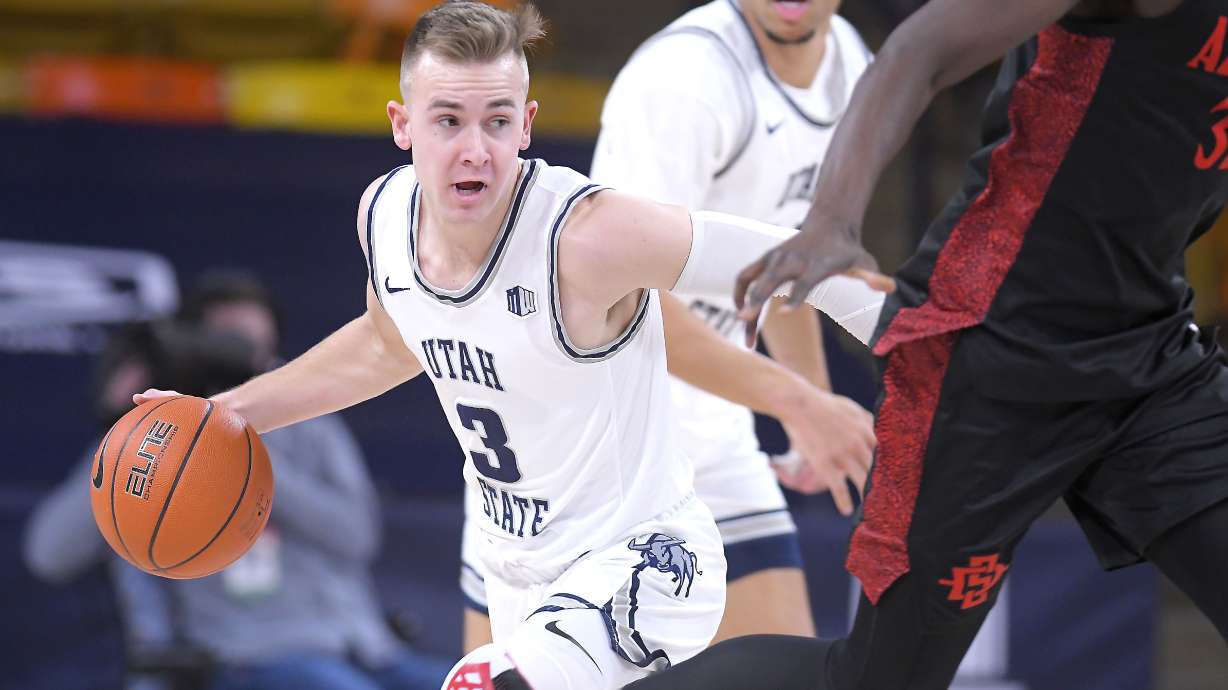 Utah State guard Steven Ashworth (3) brings the ball down the court during the first half of an NCAA college basketball game Thursday, Jan. 14, 2021, in Logan, Utah. (Eli Lucero/The Herald Journal via AP, Pool)