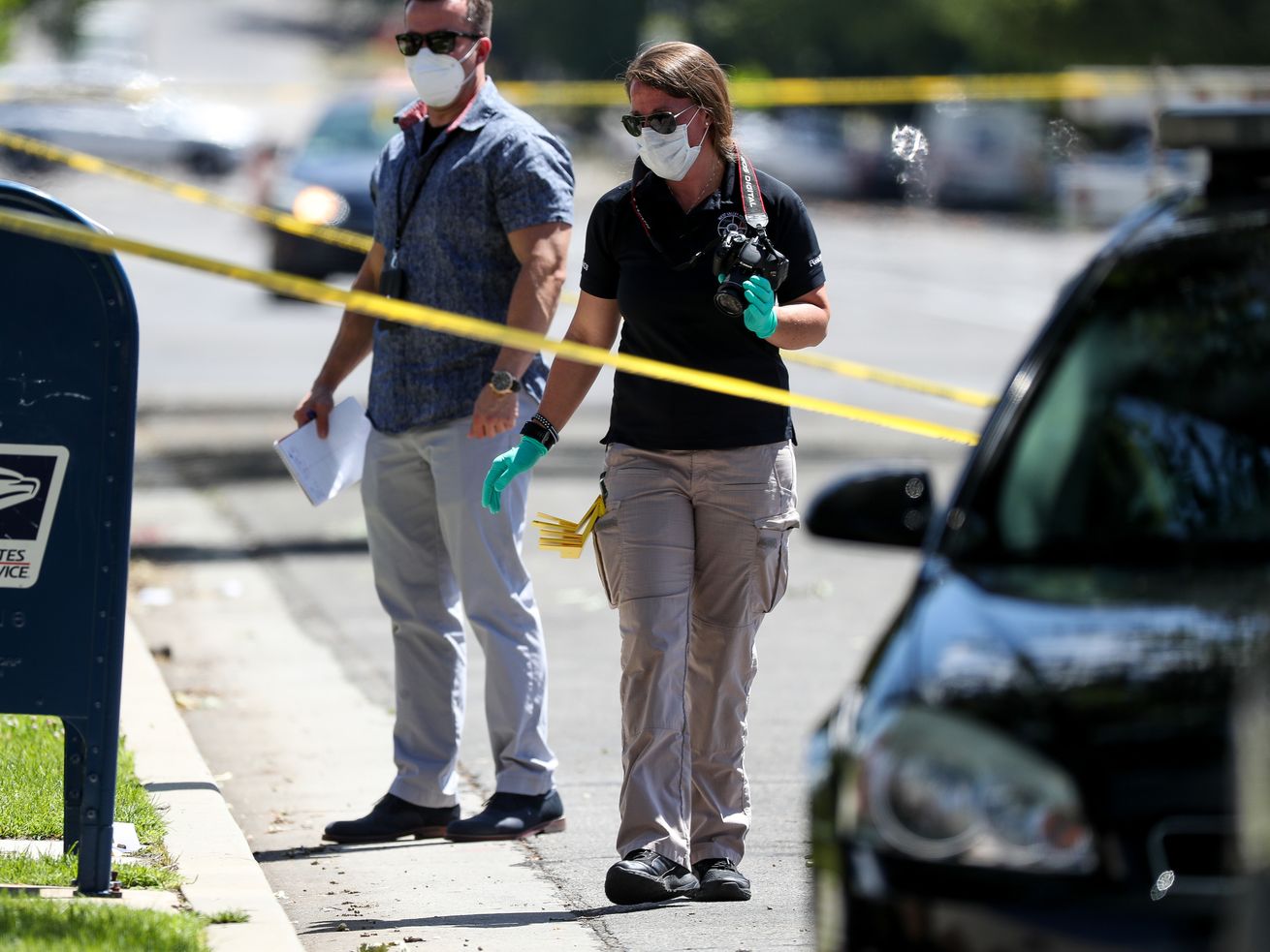 Law enforcement officers process the scene for evidence
after Salt Lake City police officers shot and killed a man on 500
South in Salt Lake City on Saturday, July 25, 2020. A police
spokesman said two officers responded to a call of a knife fight
between two men that resulted in the officers shooting and killing
one of the men.