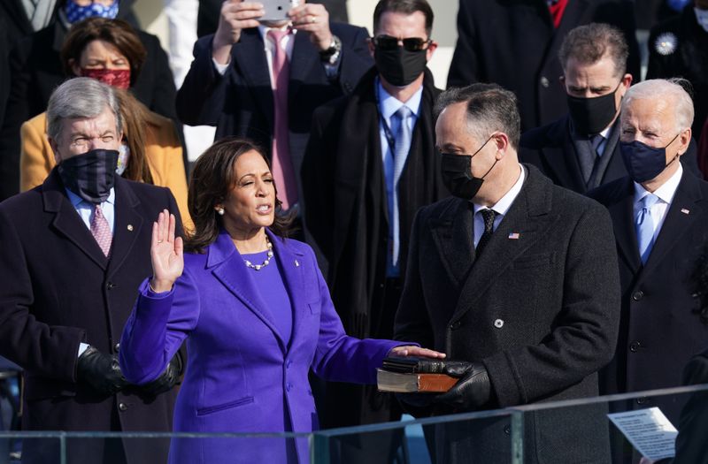 Kamala Harris is sworn in as U.S. Vice President as her spouse Doug Emhoff holds a bible during the inauguration of Joe Biden as the 46th President of the United States on the West Front of the U.S. Capitol in Washington, D.C., Jan. 20, 2021.