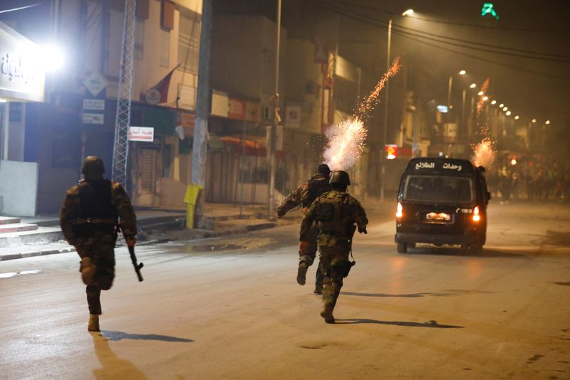 FILE PHOTO: Security forces clash with demonstrators during anti-government protests in Tunis, Tunisia, January 18, 2021. REUTERS/Zoubeir Souissi/File Photo