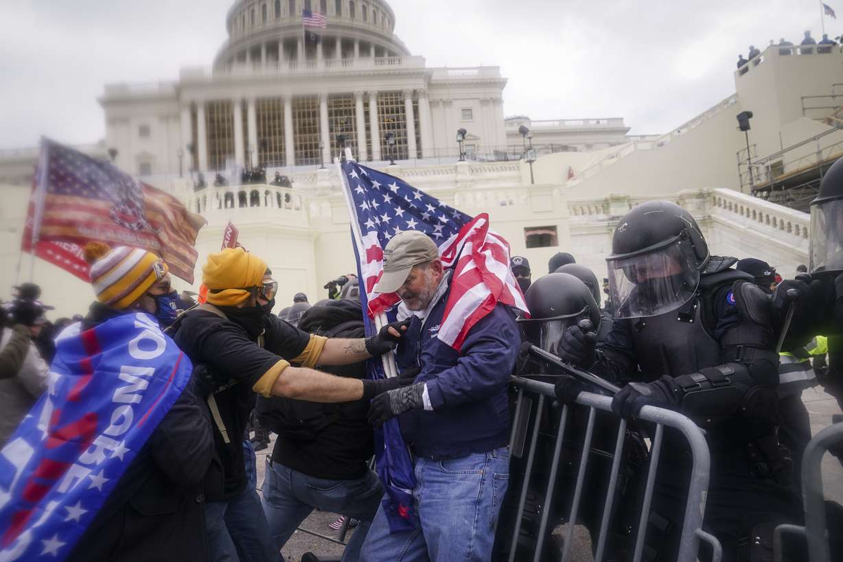 FILE - In this Jan. 6, 2021, file photo rioters try to break through a police barrier at the Capitol in Washington.