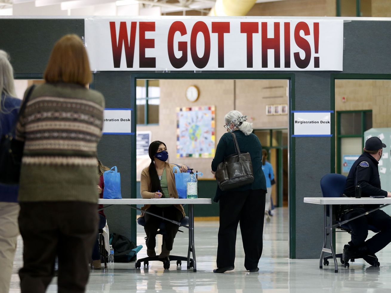 Granite School District teachers and staff wait in line
to receive the first round of the COVID-19 vaccine at Hunter Junior
High School in West Valley City on Friday, Jan. 15, 2021.