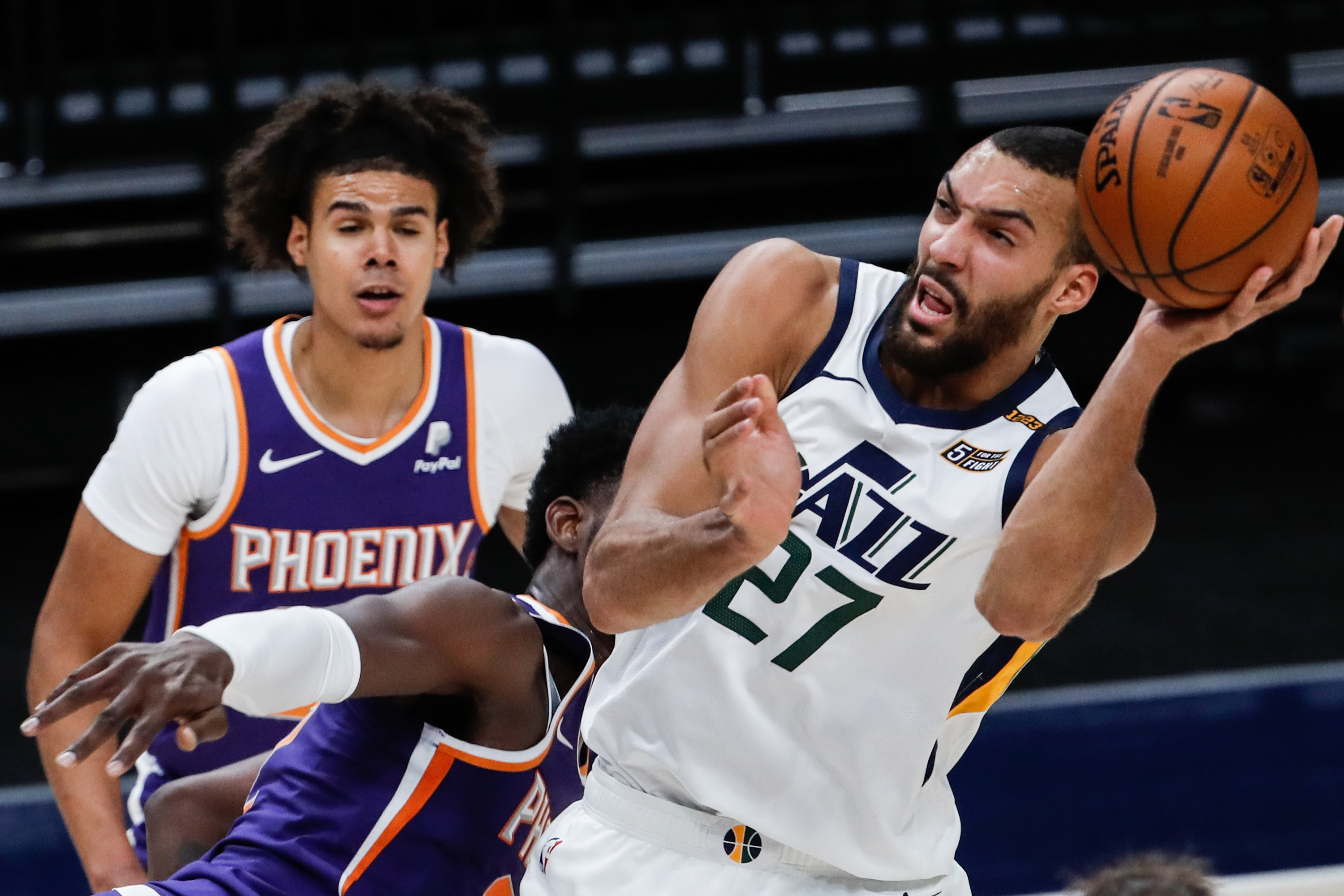 Utah Jazz center Rudy Gobert (27) is being fouled while making a layup attempt during an NBA preseason game at Vivint Smart Home Arena in Salt Lake City on Saturday, Dec. 12, 2020.