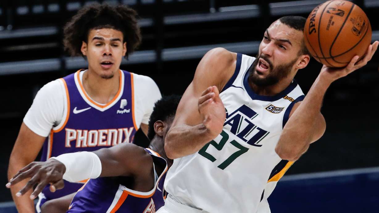 Utah Jazz center Rudy Gobert (27) is being fouled while making a layup attempt during an NBA preseason game at Vivint Smart Home Arena in Salt Lake City on Saturday, Dec. 12, 2020.