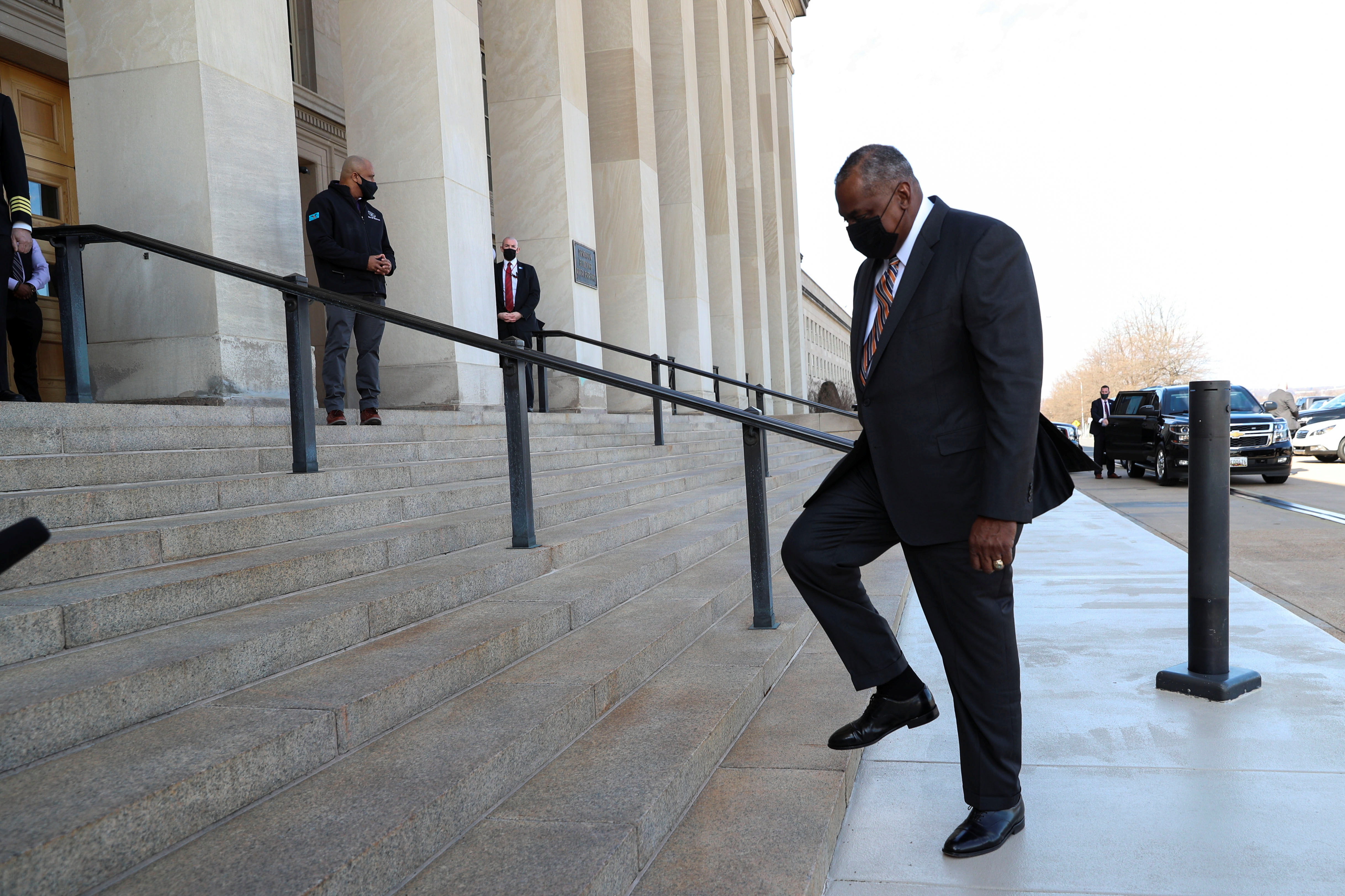 Newly confirmed U.S. Defense Secretary Lloyd Austin (R) is greeted as he arrives to begin his first day in office at the Pentagon in Arlington, Virginia, U.S., January 22, 2021.
