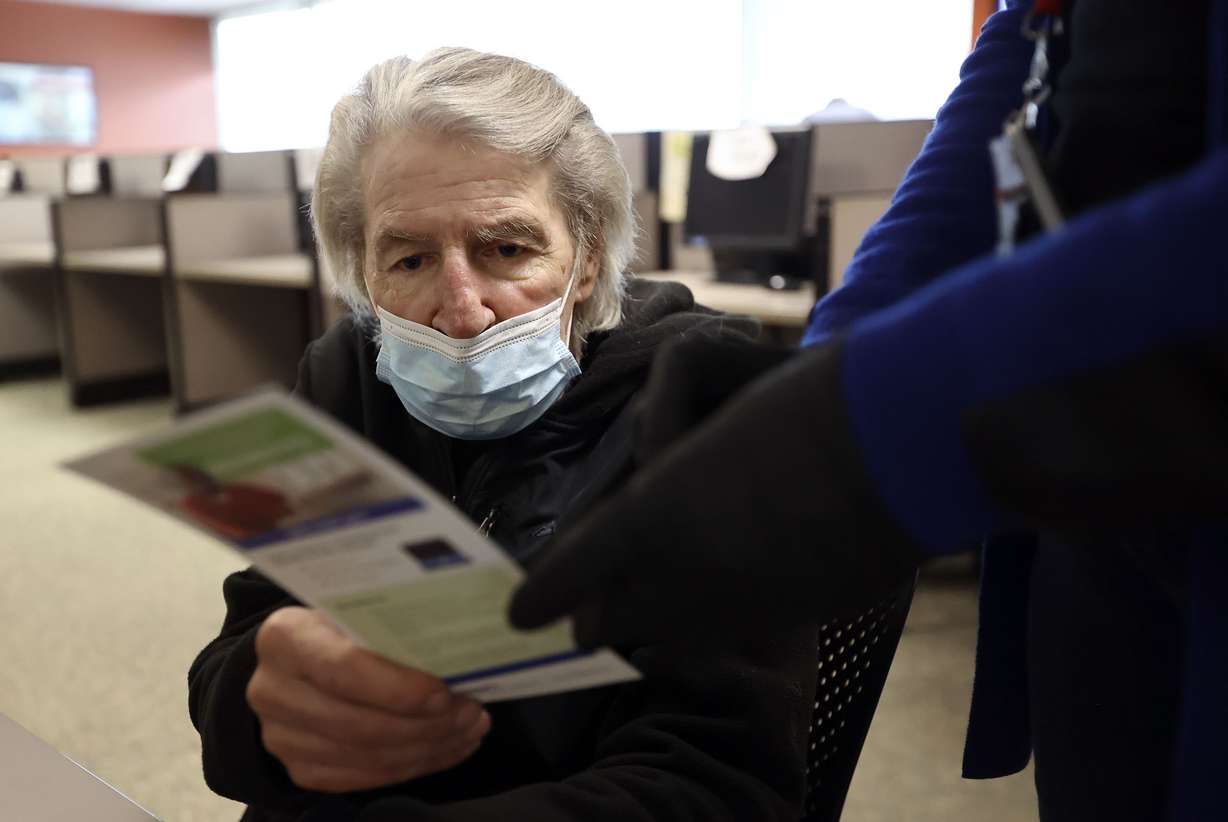 Randi Boyakin looks at a flyer with instructions for how to file for unemployment over the phone at the Department of Workforce Services office in Salt Lake City on Friday, Jan. 22, 2021. The state unemployment rate dropped to 3.6%.