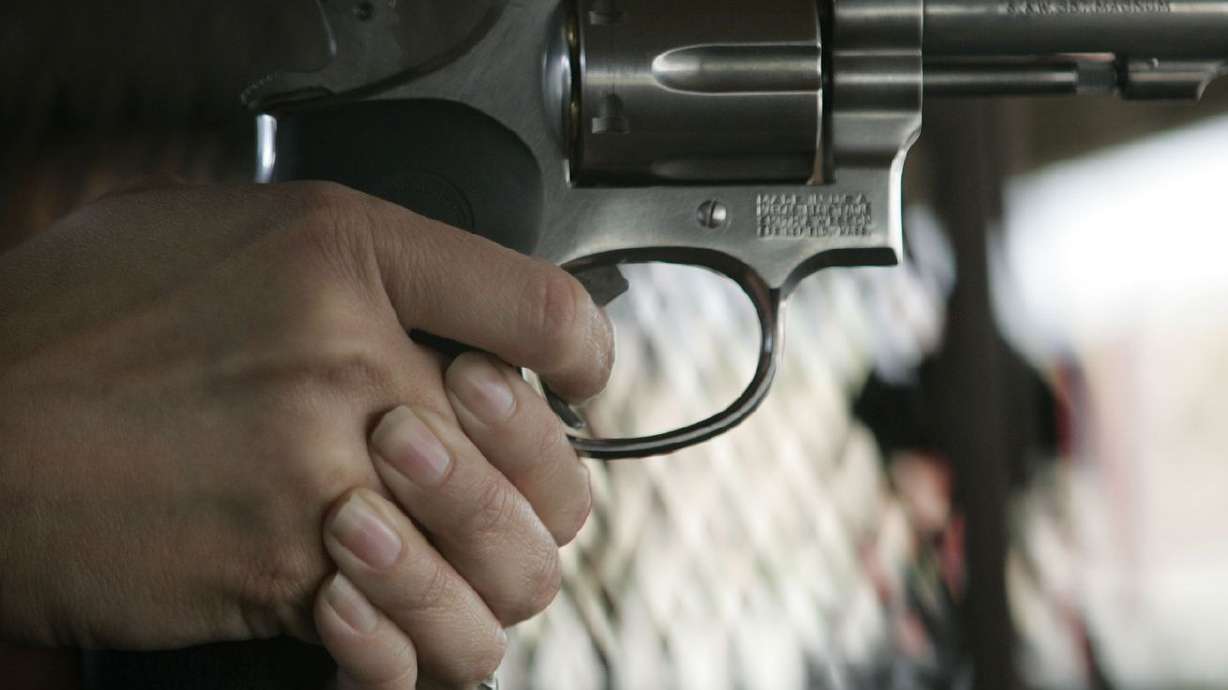 A student holds a gun during a conceal and carry
weapons certification for members of the media at Lee Kay Shooting
Range in Salt Lake City Sunday, May 31, 2009.
