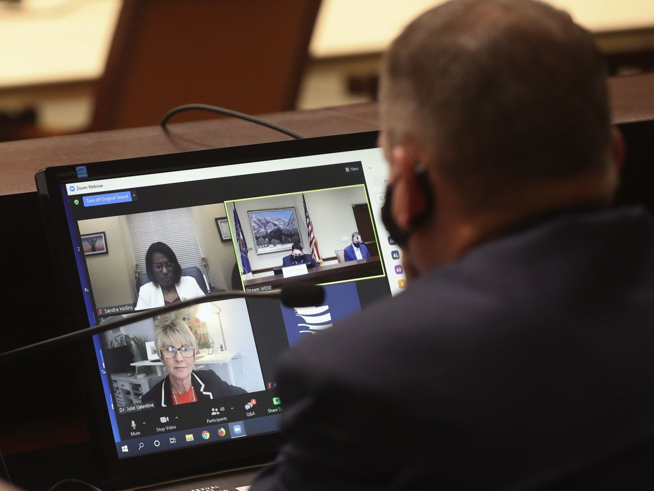 Rep. Paul Ray, R-Clearfield, listens to Dr. Julie
Valentine, a BYU professor and sexual assault nurse examiner,
bottom left, as she speaks on a Zoom call during a House Law
Enforcement and Criminal Justice Standing Committee in the House
Building at the Capitol complex in Salt Lake City on Friday, Jan.
22, 2021. Valentine discussed HB0168, which seeks to prohibit
over-the-counter sexual assault evidence kits.