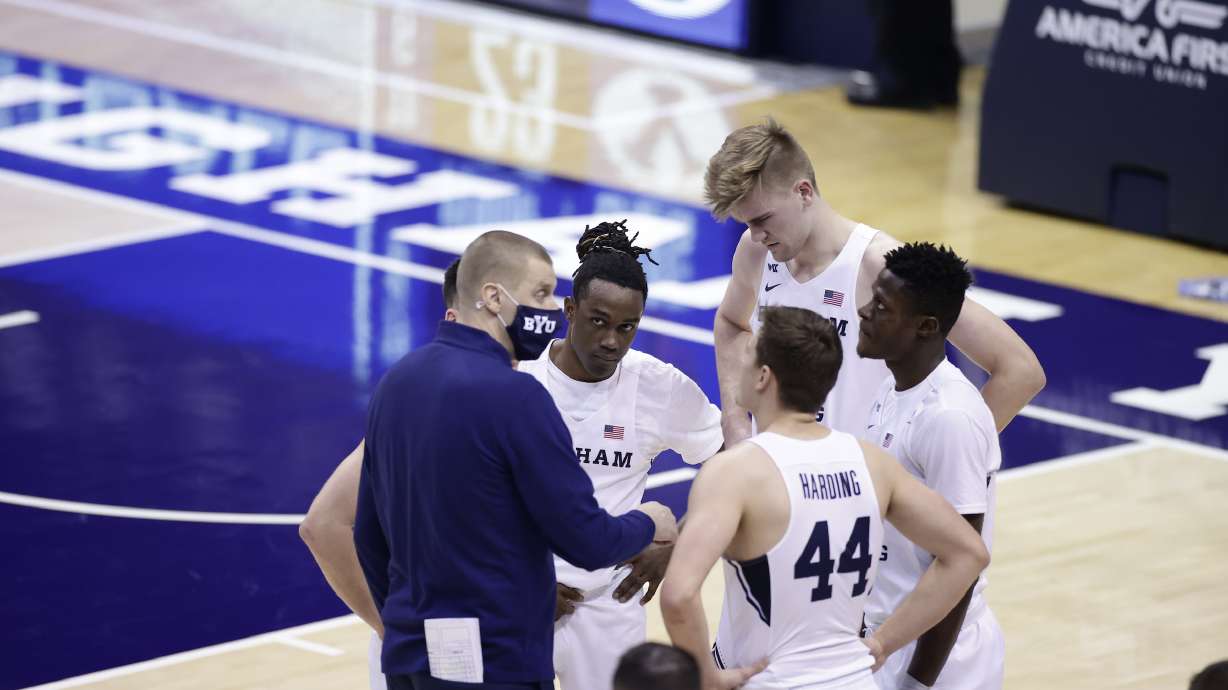 BYU guard Brandon Averette looks at coach Mark Pope during a timeout during a West Coast Conference game against Pepperdine, Saturday, Jan. 23, 2021 in Provo.