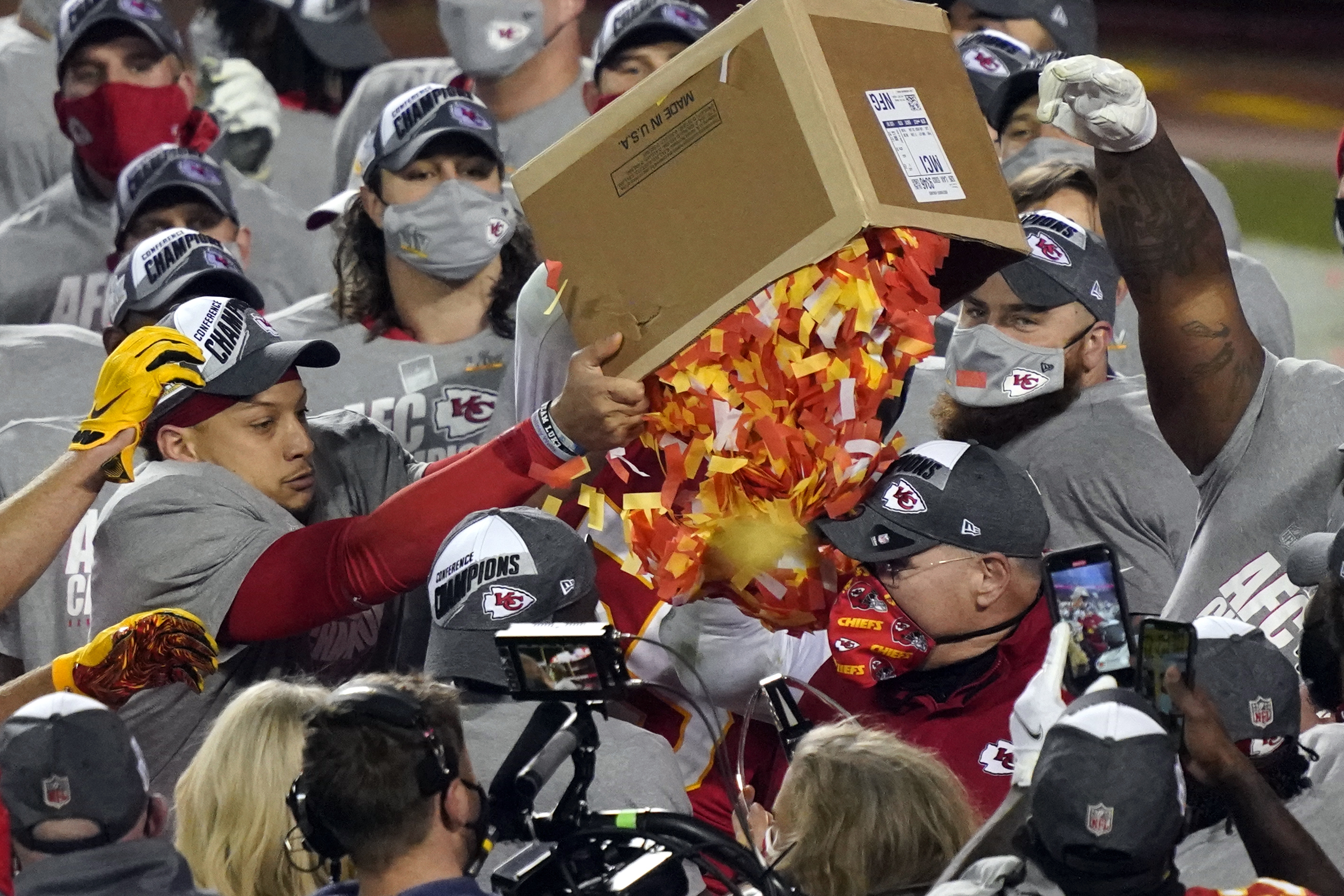 Kansas City Chiefs players dump a box of confetti on head coach Andy Reid after the AFC championship NFL football game against the Buffalo Bills, Sunday, Jan. 24, 2021, in Kansas City, Mo. The Chiefs won 38-24.