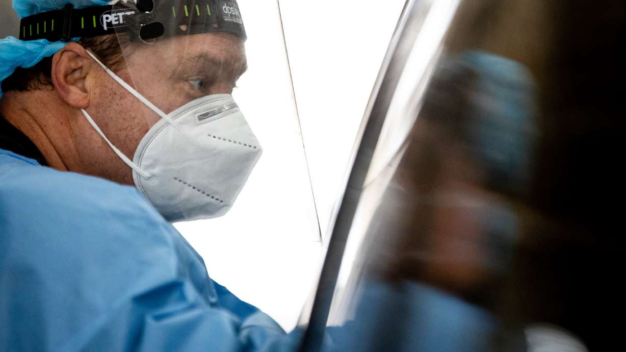 Utah National Guard Sgt. 1st Class Sean Conorich administers COVID-19 rapid tests at the Fairpark in Salt Lake City on Saturday, Jan. 23, 2021.