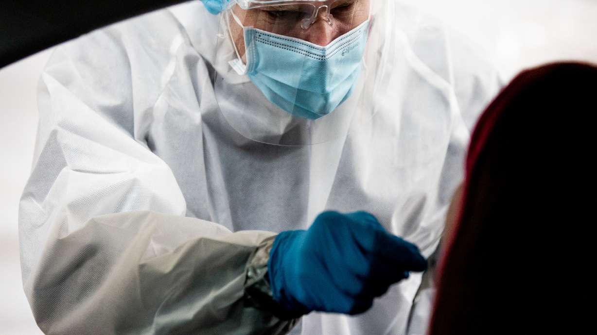 Utah National Guard Master Sgt. Jaime Phair administers a COVID-19 rapid test at the Fairpark in Salt Lake City on Saturday, Jan. 23, 2021.