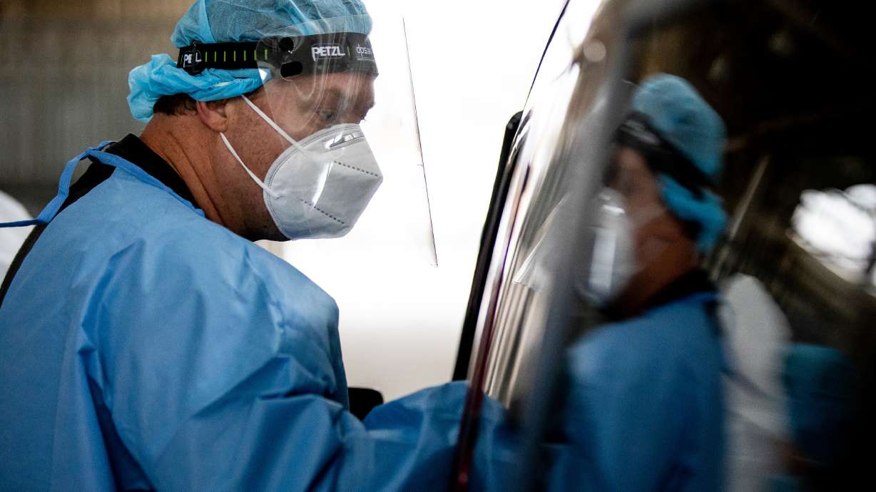 Utah National Guard Sgt. 1st Class Sean Conorich conducts COVID-19 rapid testing at the Fairpark in Salt Lake City on Saturday, Jan. 23, 2021.