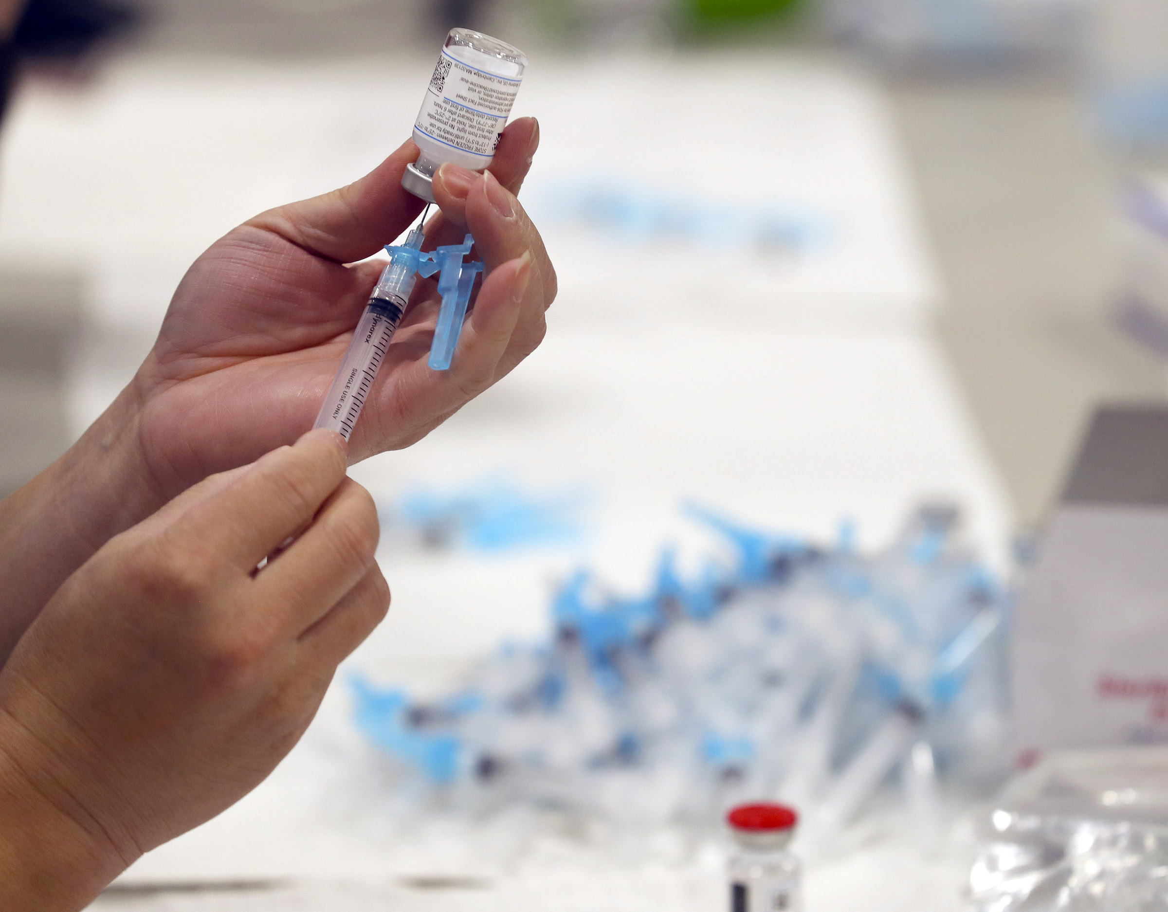 Syringes are filled with the Moderna COVID-19 vaccine at Salt Lake County's mass vaccination site at the Mountain America Expo Center in Sandy on Monday, Jan. 18, 2021.