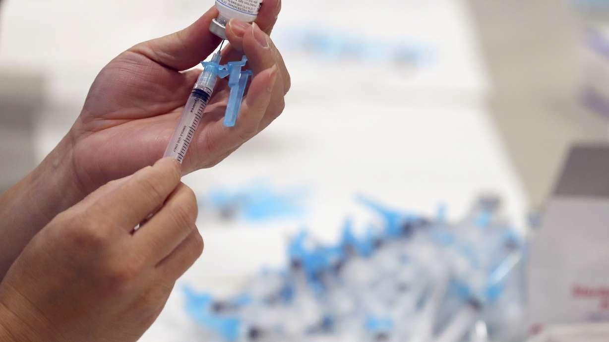 Syringes are filled with the Moderna COVID-19 vaccine at Salt Lake Countyâ??s mass vaccination site at the Mountain America Expo Center in Sandy on Monday, Jan. 18, 2021.