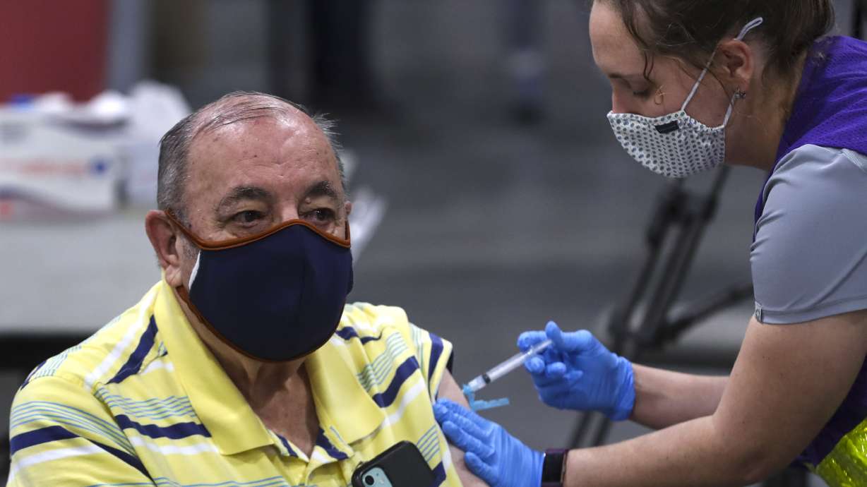 Richard Durrant receives his COVID-19 vaccine from Megan Boren, a Salt Lake County Health Department advanced EMT, at the countyâ??s mass vaccination site at the Mountain America Expo Center in Sandy on Monday, Jan. 18, 2021. Durrant and his wife, Joyce Durrant, were receiving their first doses of the Moderna vaccine.