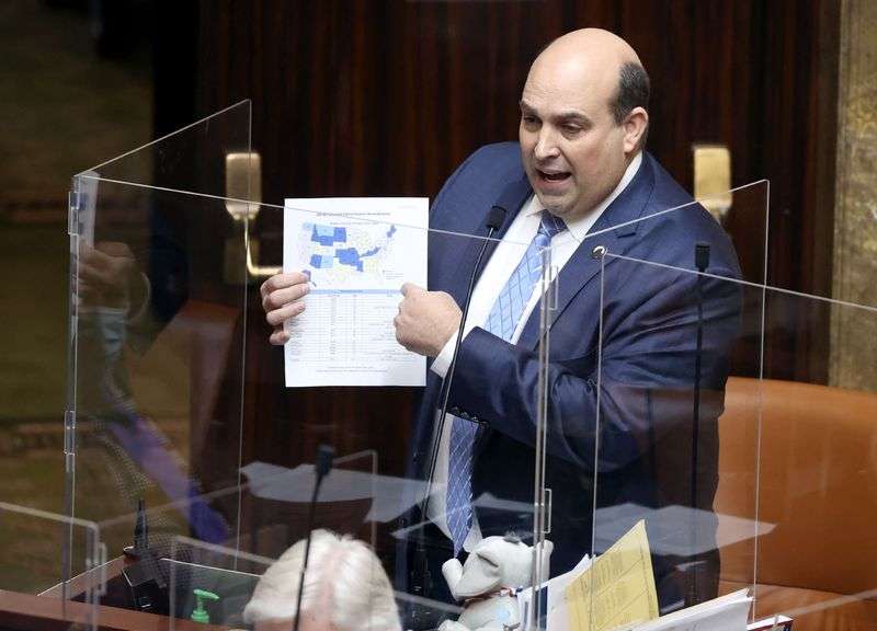 Rep. Walt Brooks, R-St. George, holds a map of states that don’t require a permit to carry a concealed firearm as the House discusses his bill, HB60, at the Capitol in Salt Lake City on Tuesday, Jan. 26, 2021.