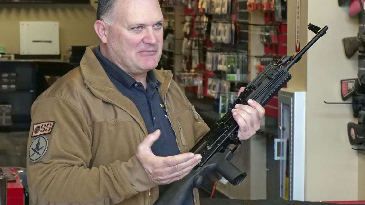 Clark Aposhian, chairman of the Utah Shooting Sports
Council, demonstrates how a bump stock works when attached to a
semi-automatic rifle at the Gun Vault store and shooting range
Wednesday, Oct. 4, 2017, in South Jordan.