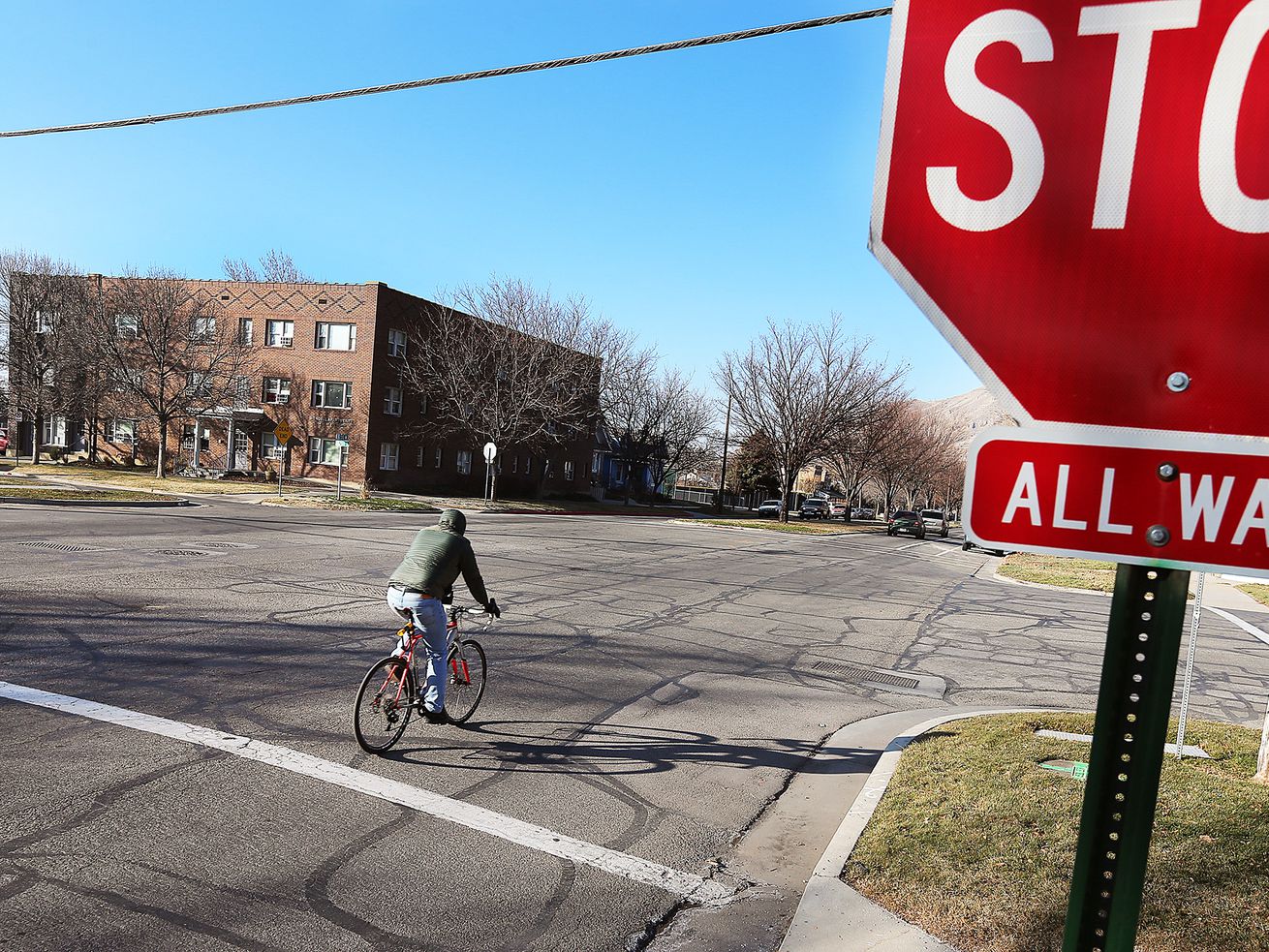 A bicyclist rides past a stop sign in Salt Lake City on Feb. 13, 2018. With two months left in 2022, Utah has already seen a 30-plus-year record in the number of bicyclists dying after being hit by vehicles.
