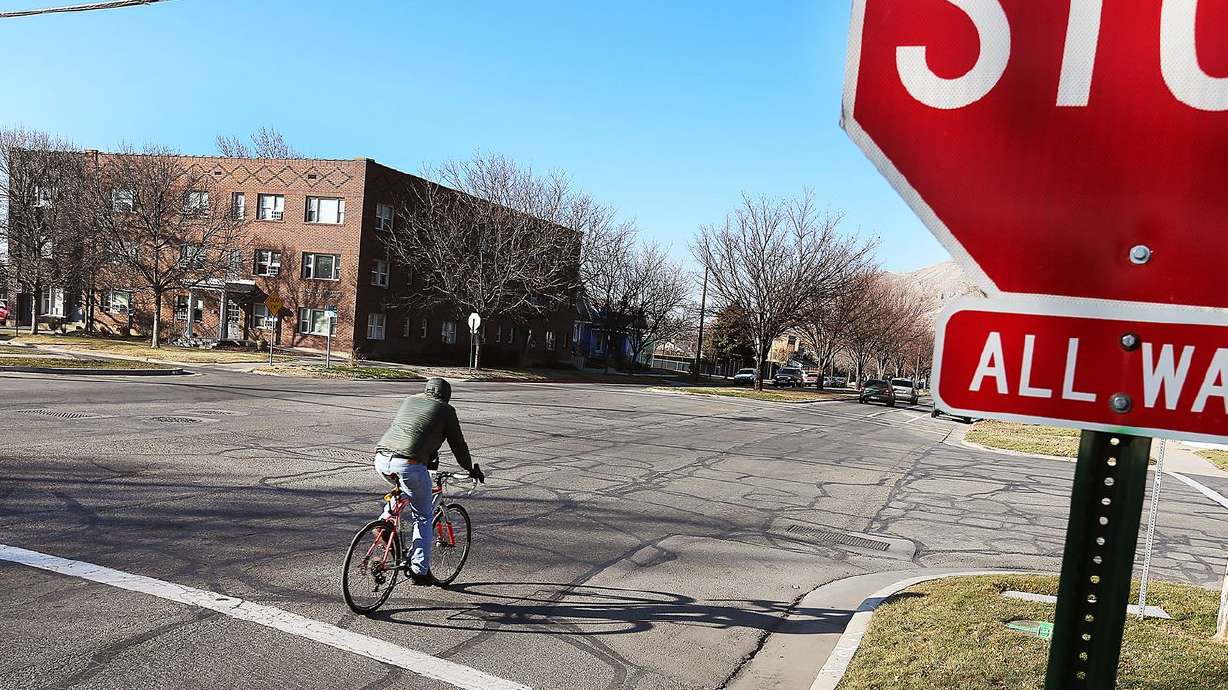 A bicyclist rides past a stop sign in Salt Lake City on Feb. 13, 2018. With two months left in 2022, Utah has already seen a 30-plus-year record in the number of bicyclists dying after being hit by vehicles.