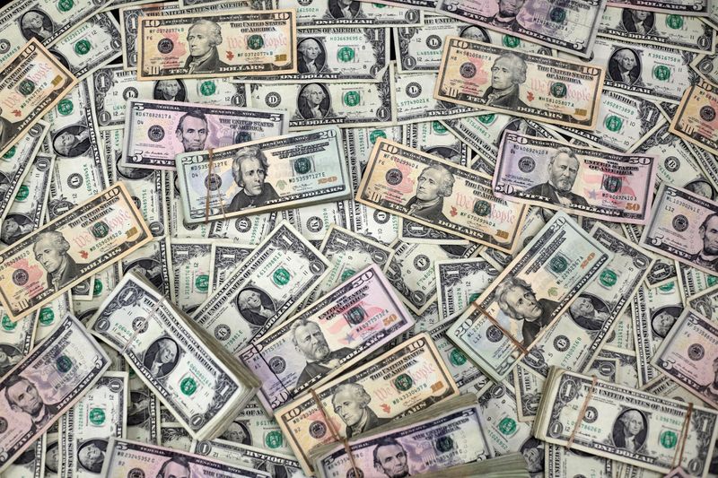 FILE PHOTO: U.S. Dollar banknotes are seen in this photo illustration taken February 12, 2018. REUTERS/Jose Luis Gonzalez/Illustration