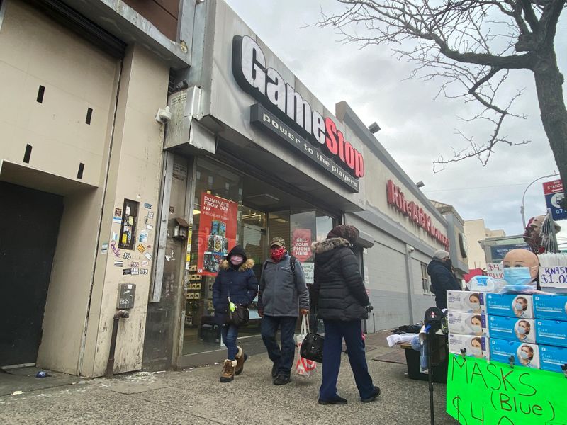 FILE PHOTO: People walk past a GameStop store in New York, U.S., January 27, 2021.  REUTERS/Nick Zieminski/File Photo