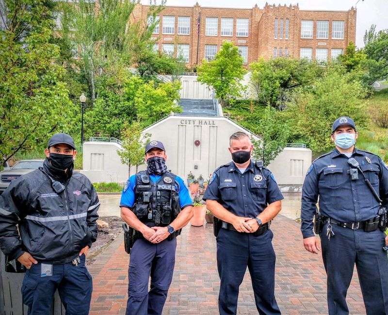 Park City Police Department civilian employee Junior
Enrique Sanchez, left, poses for a photo with Park City police
officer Comer, Capt. Leatham and officer Libertini.