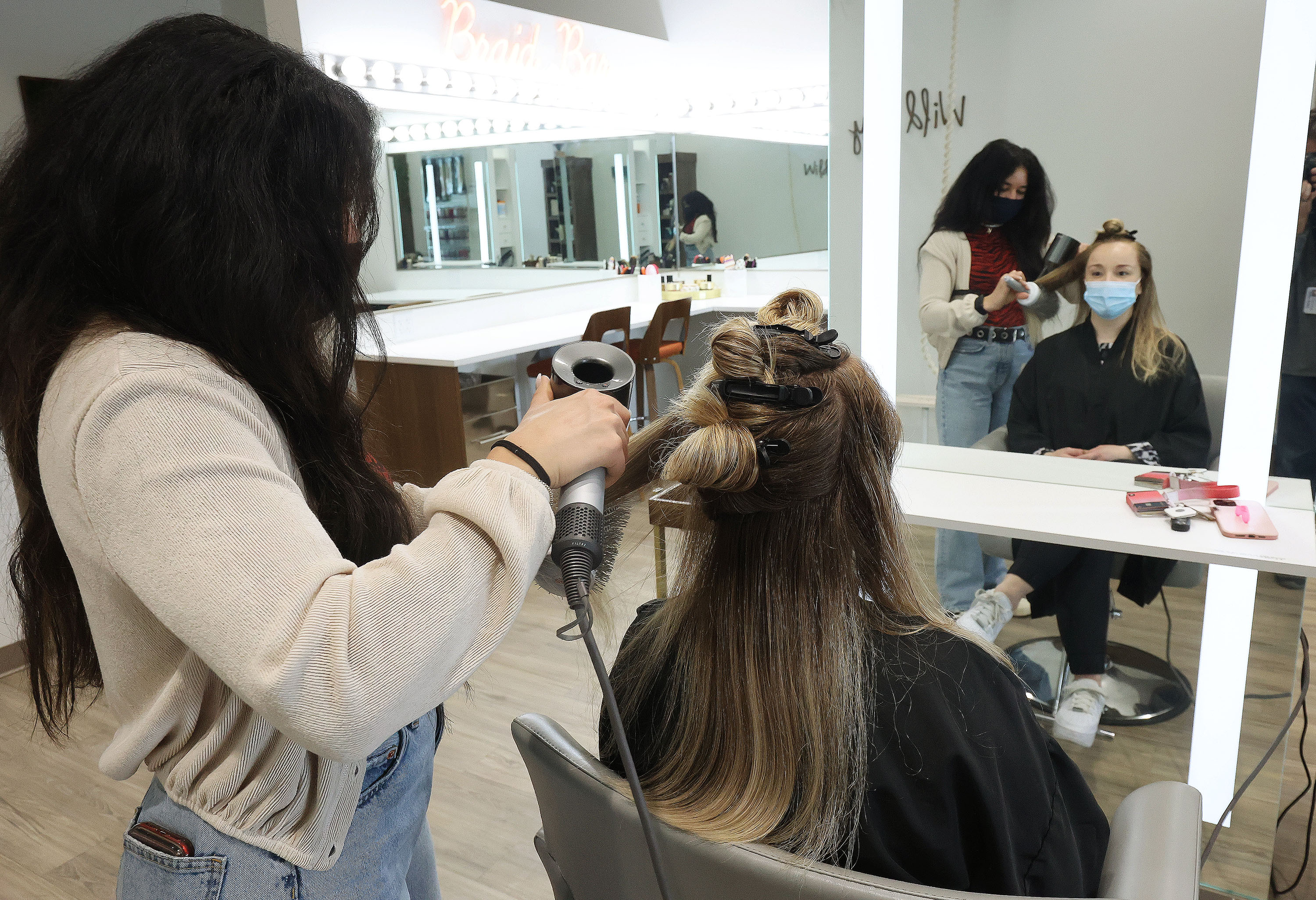 Kyra Scott, left, styles Cassie Stringham's hair at Wild Ivy Blow Dry Bar in American Fork on Thursday, Jan. 28, 2021.