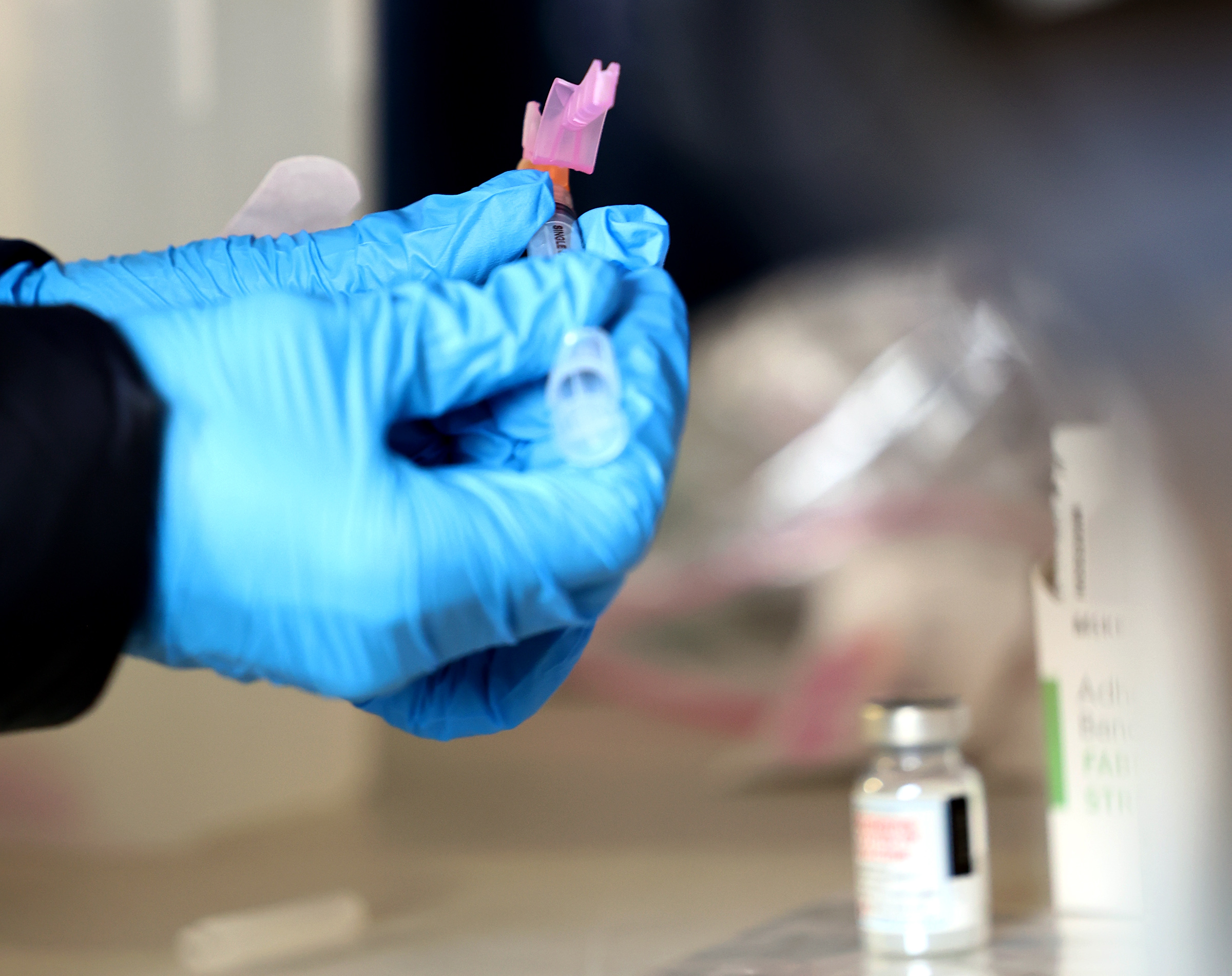 Kelsey Merlo, a pharmacy intern and a University of Utah pharmacy student, prepares a COVID-19 vaccination for Laurence A. Morgan at the Fourth Street Clinic in Salt Lake City on Tuesday, Jan. 26, 2021. The Salt Lake County Health Department allocated 80 doses of the vaccine to the clinic, which serves many people experiencing homelessness.