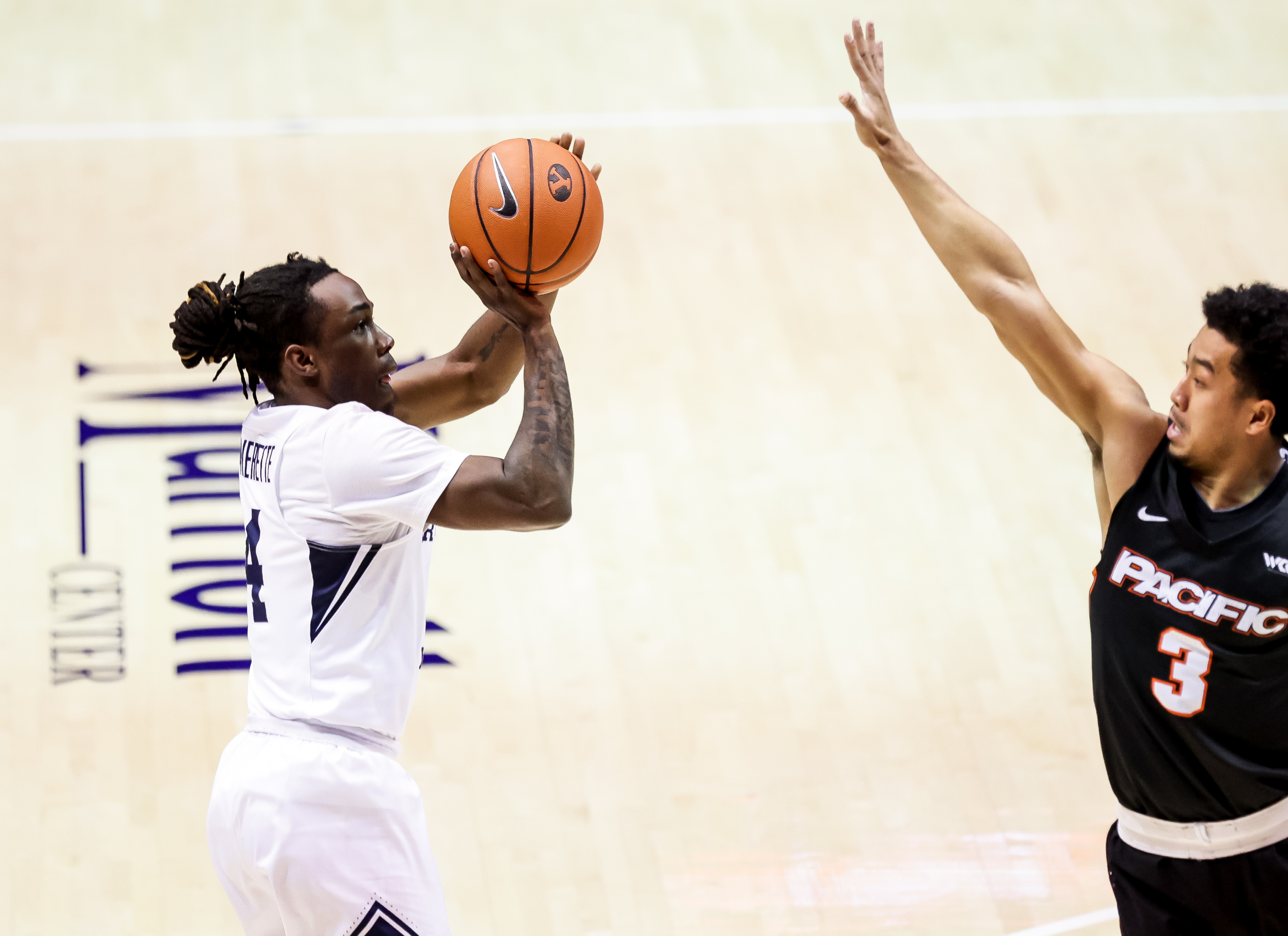 Brigham Young Cougars guard Brandon Averette (4) shoots over Pacific Tigers guard Pierre Crockrell II (3) at the Marriott Center in Provo on Saturday, Jan. 30, 2021.