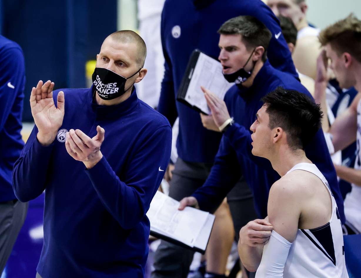 BYU coach Mark Pope works the sideline next to Alex Barcello and assistant Cody Fueger, background, during the game against the Pacific Tigers at the Marriott Center in Provo on Saturday, Jan. 30, 2021.