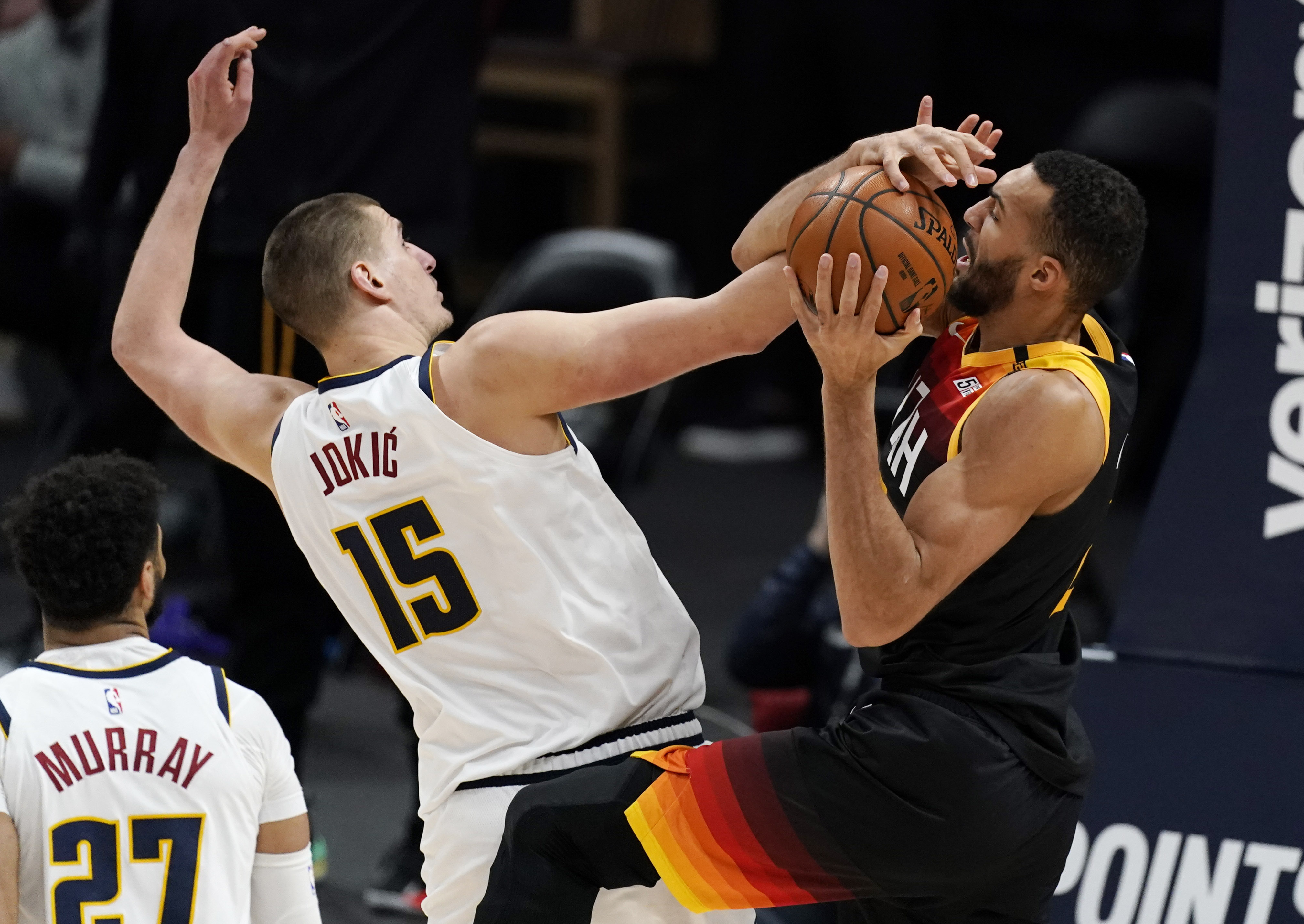 Utah Jazz center Rudy Gobert, right, fights for control of a rebound with Denver Nuggets center Nikola Jokic in the second half of an NBA basketball game Sunday, Jan. 31, 2021, in Denver. (AP Photo/David Zalubowski) [Jan-31-2021]