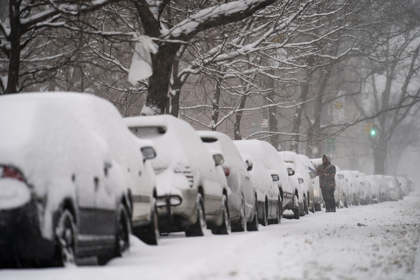 A motorist clears his car of snow in the Clinton Hill neighborhood of the Brooklyn borough of New York, Monday, Feb. 1, 2021.