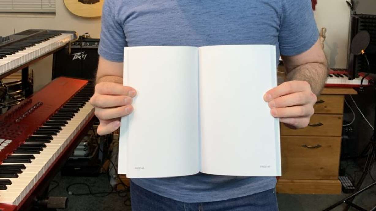 Jerald Simon holds a copy of a knock off version of his music book being sold on Amazon.
