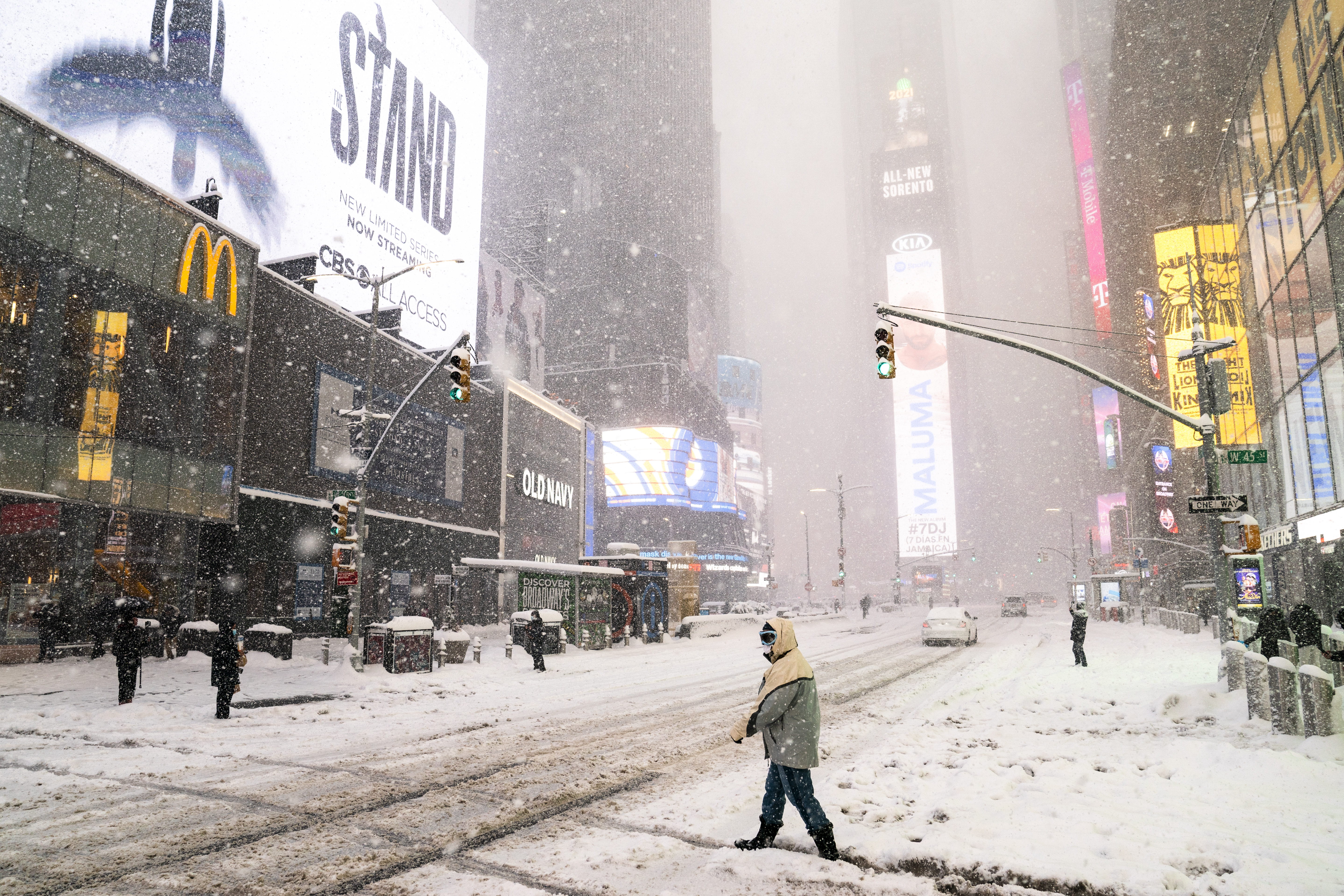 Pedestrians make their way through Times Square during a snowstorm, Monday, Feb. 1, 2021, in the Manhattan borough of New York.