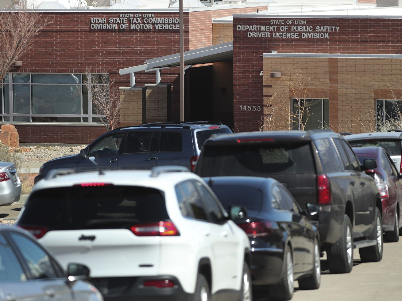 Hundreds of cars wait in line at the Division of
Motor Vehicles drive-thru window in Draper on Friday, April 3,
2020. Some waited in line for hours.