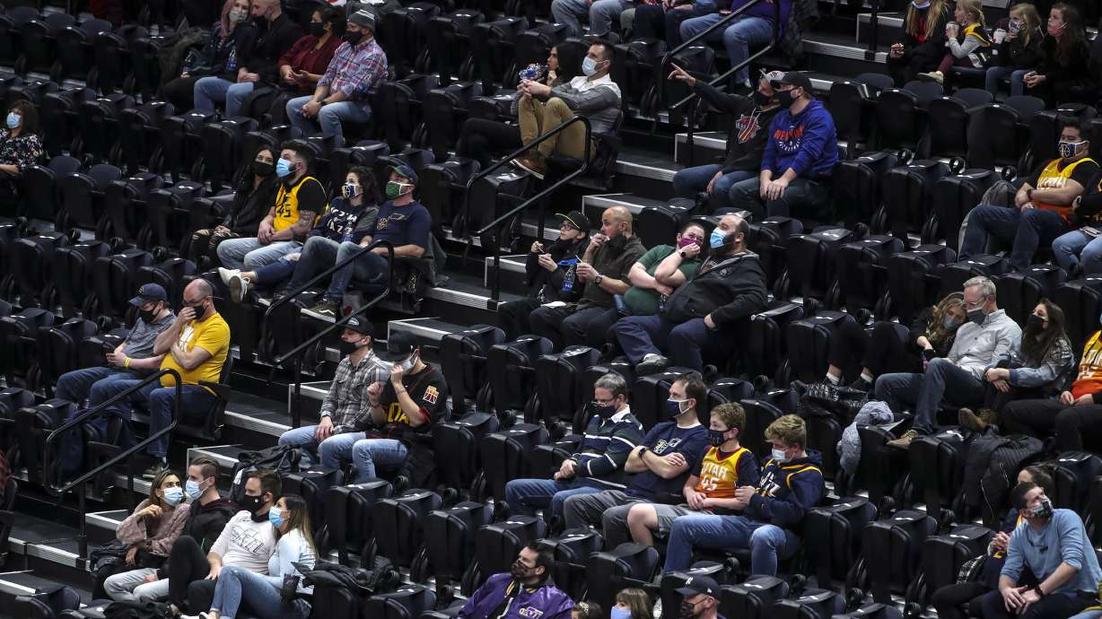 Fans social distance as they watch the New York Knicks and Utah Jazz NBA basketball game at Vivint Smart Home Arena in Salt Lake City on Tuesday, Jan. 26, 2021.