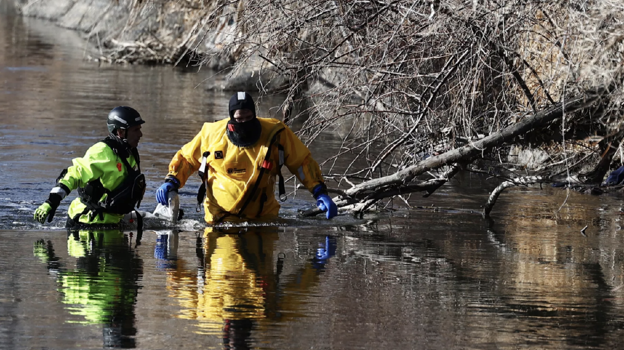 Crews recover a body from the Jordan River near the International Peace Gardens, 1100 W. Fremont Ave. in Salt Lake City, on Sunday, Jan. 31, 2021.