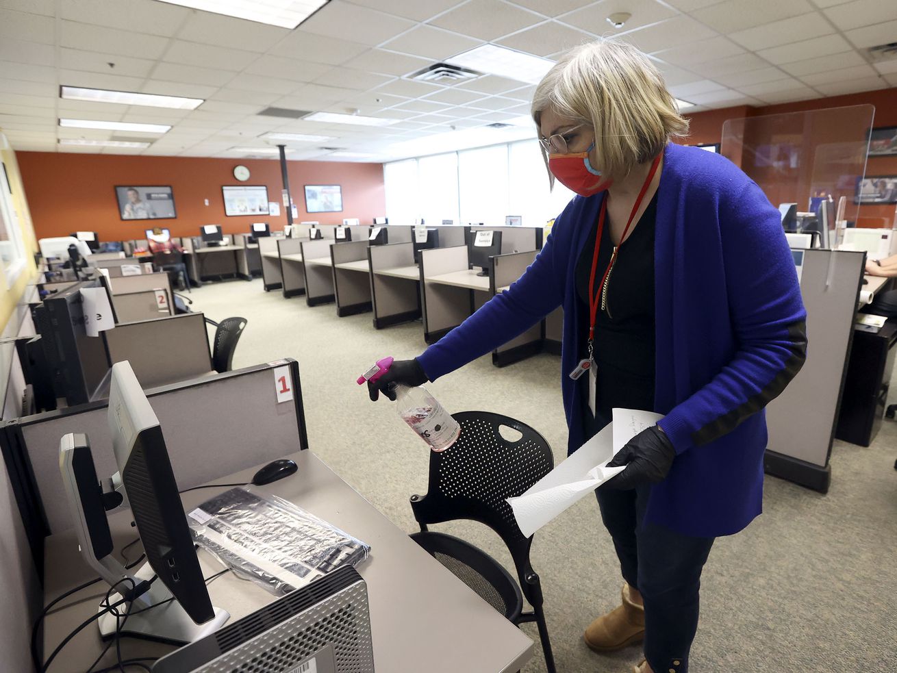 Gayane Manukyan, Department of Workforce Services
employment counselor, sanitizes a work station between clients at
the department’s office in Salt Lake City on Friday, Jan. 22, 2021.
The state unemployment rate dropped to 3.6%.